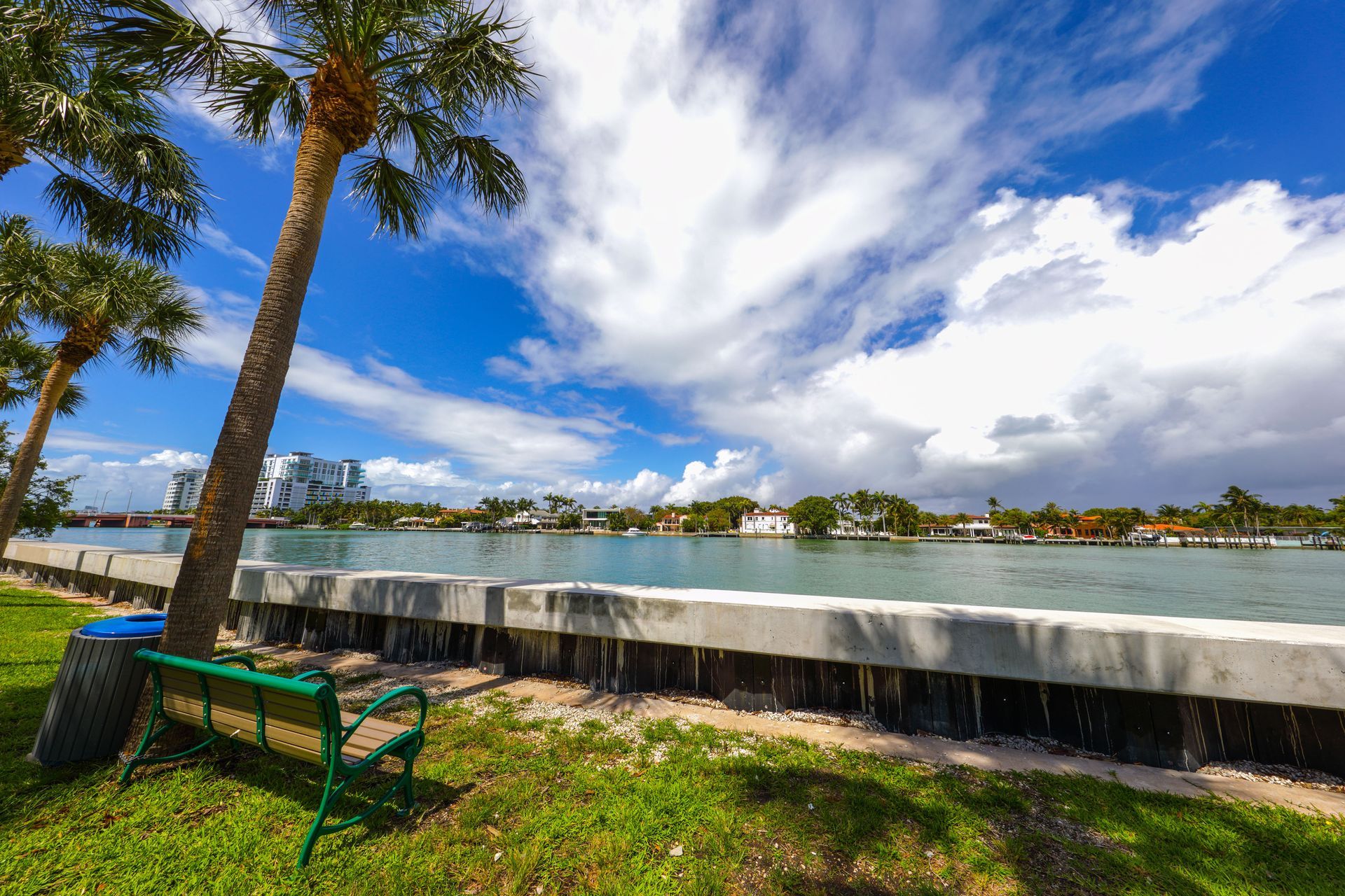 Concrete retaining wall along a landscaped waterfront bank